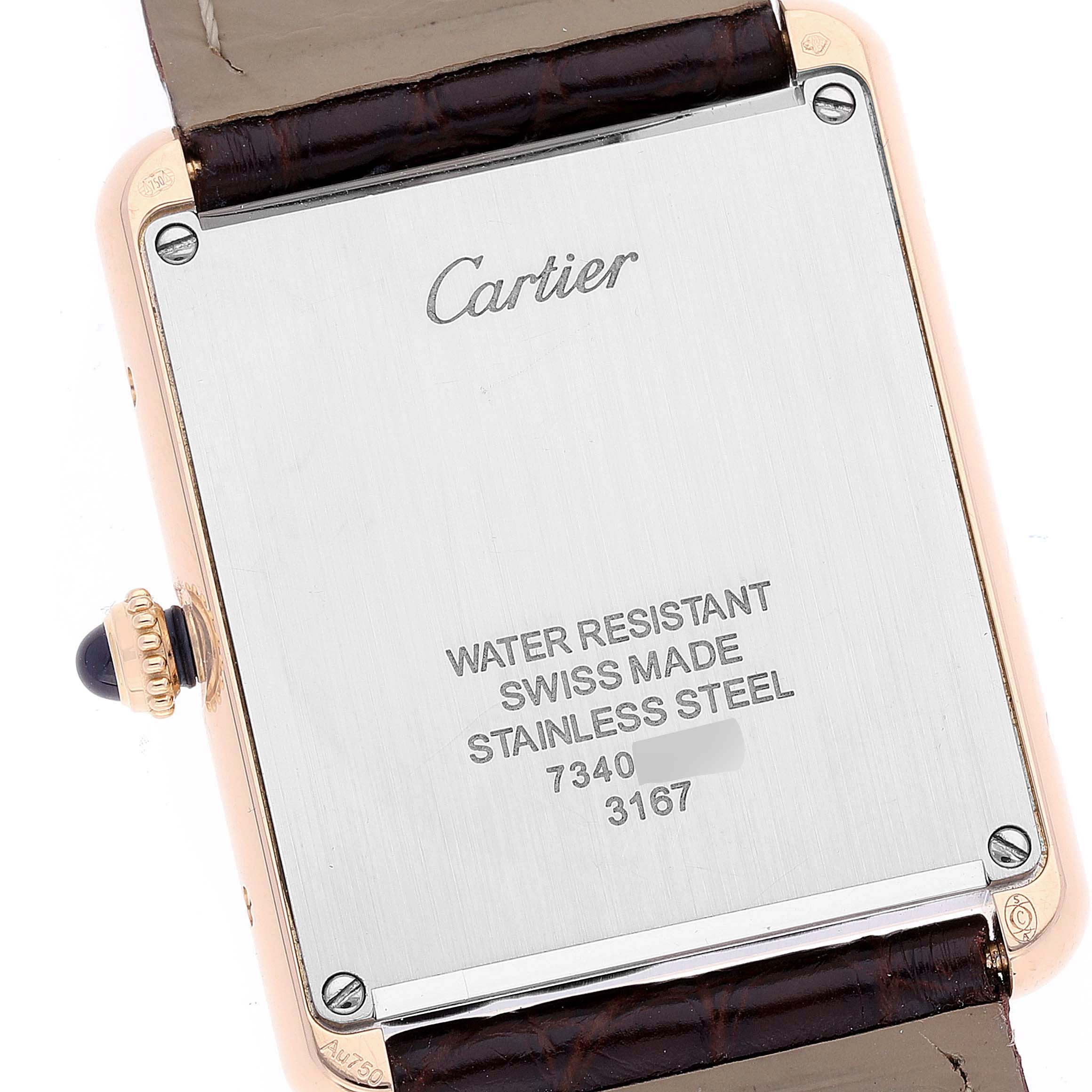 The image shows the back case of the Cartier Tank Solo W5200025 Men
s Rose Gold Silver Dial W5200025 Men
s Rose Gold Silver Dial watch focusing on its inscriptions and serial number.