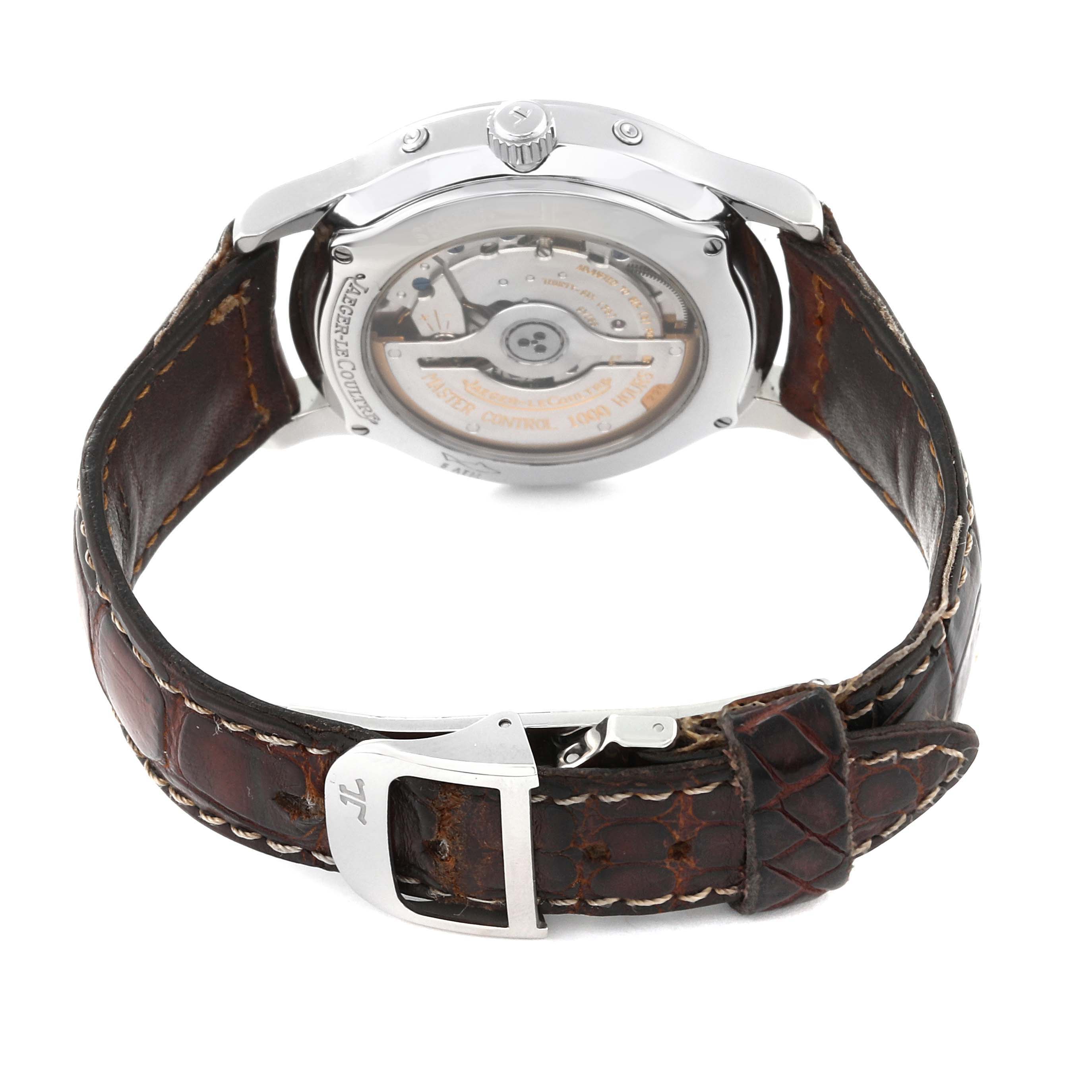 The image shows the back view of a Jaeger-LeCoultre Master model watch with a brown leather strap and visible movement.
