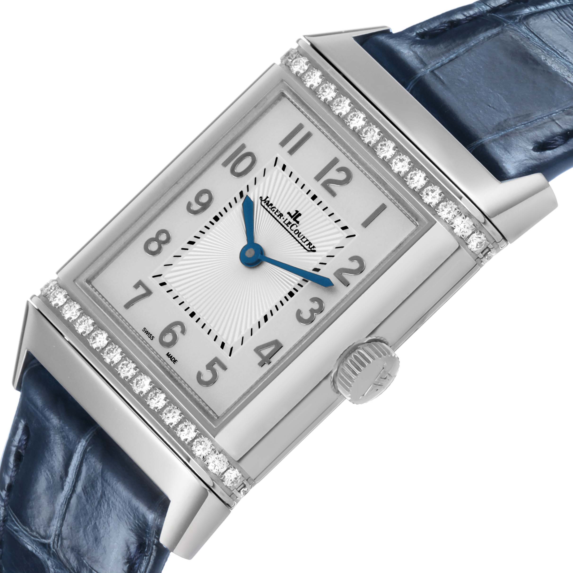 The Jaeger-LeCoultre Reverso watch is shown at an angled view, highlighting the face, crown, and blue strap.