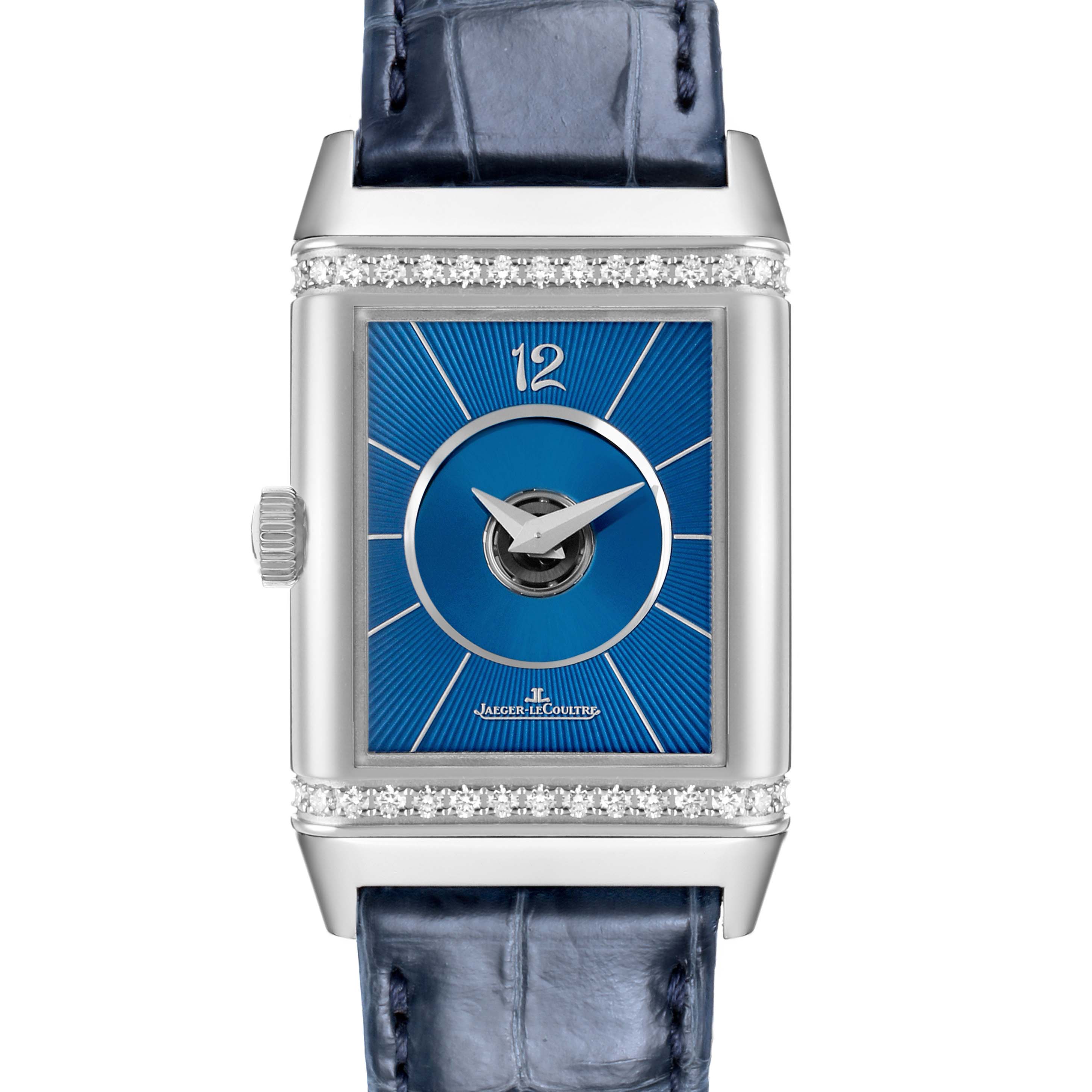 The Jaeger-LeCoultre Reverso watch is shown from the front, highlighting the dial and blue leather strap.
