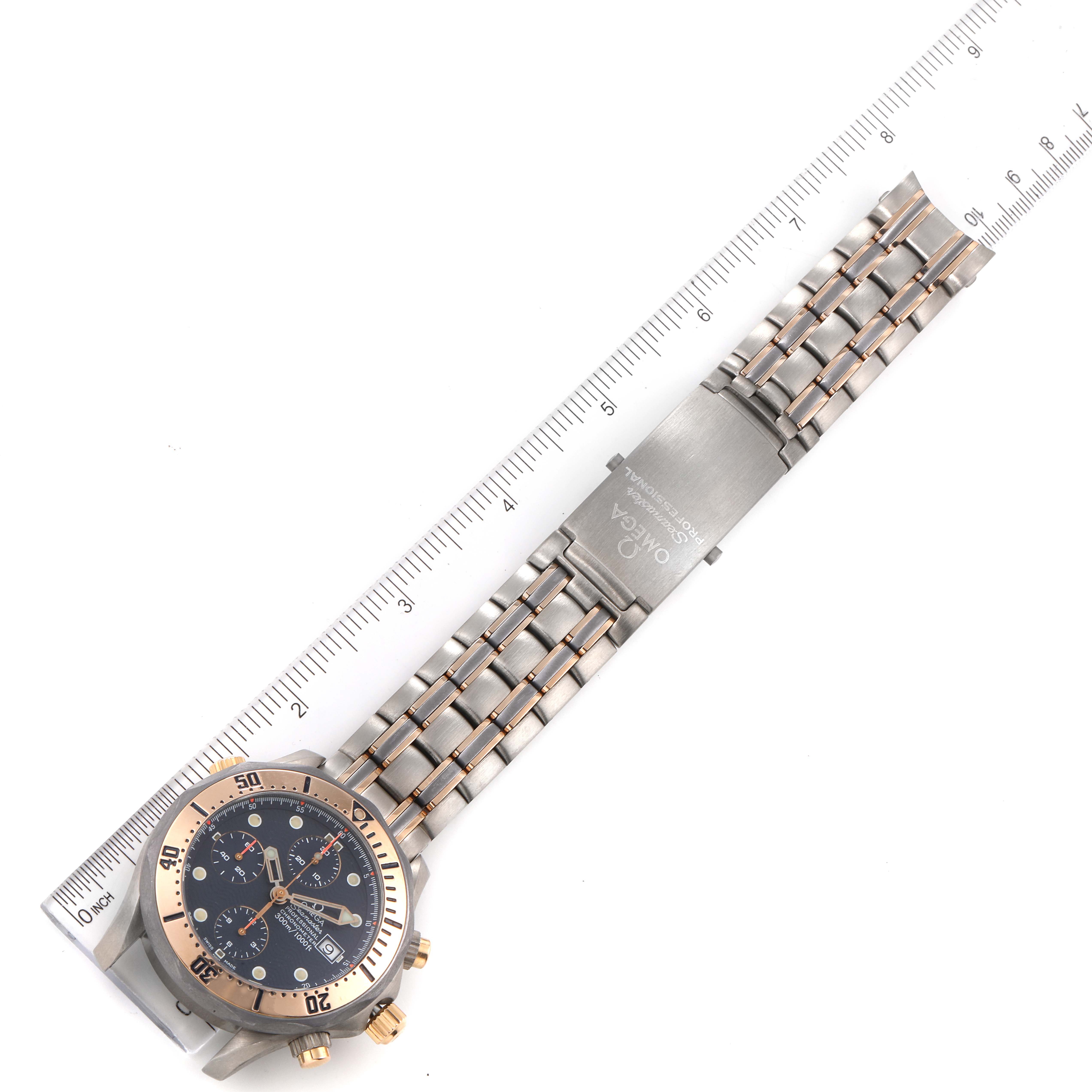 This image shows an Omega Seamaster 2296.80.00 Men's Titanium Blue Dial 2296.80.00 Men's Titanium Blue Dial watch from a top-down view, including the face, bezel, and metal bracelet with a ruler for scale.