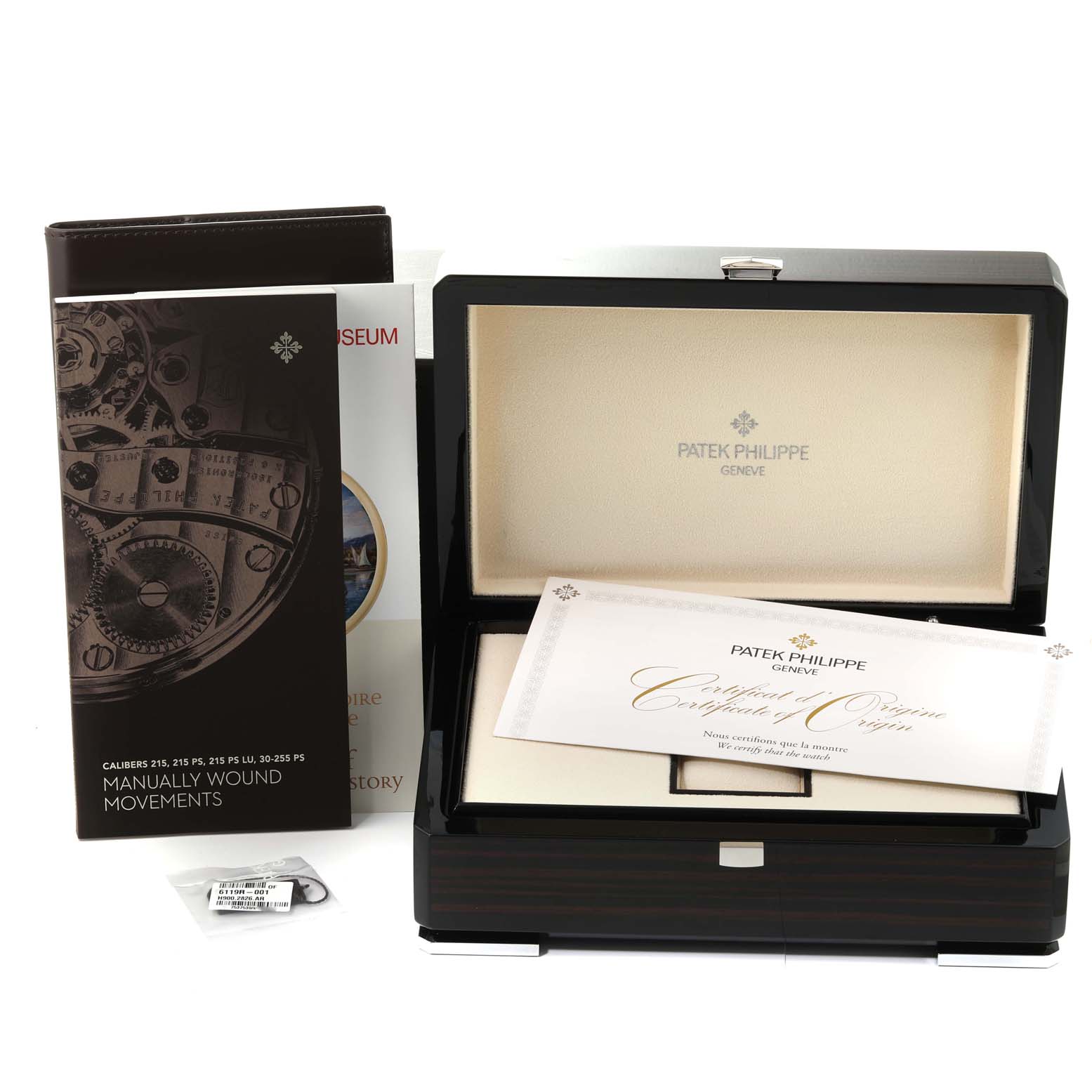 The image shows the box, certificate, and manuals for the Patek Philippe Calatrava 6119R-001 Men's Rose Gold Silver Dial 6119R-001 Men's Rose Gold Silver Dial watch.