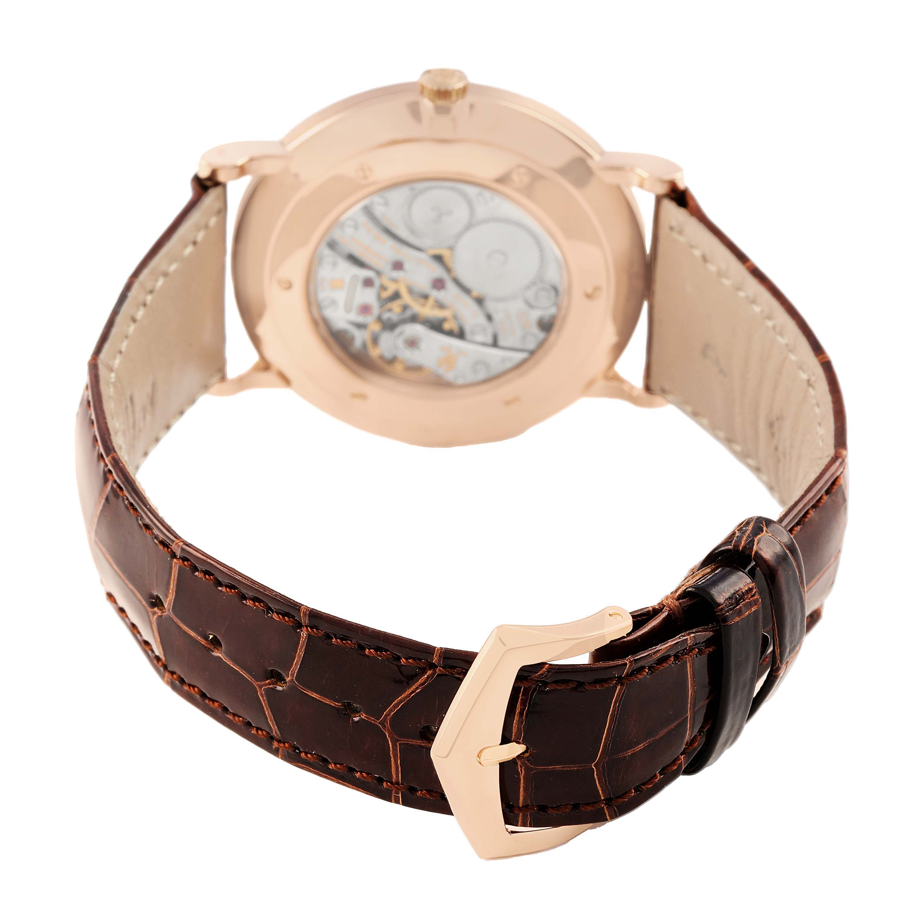 The image shows the back of the Patek Philippe Calatrava 5119R Men's Yellow Gold White Dial watch, highlighting the movement, case, and leather strap.