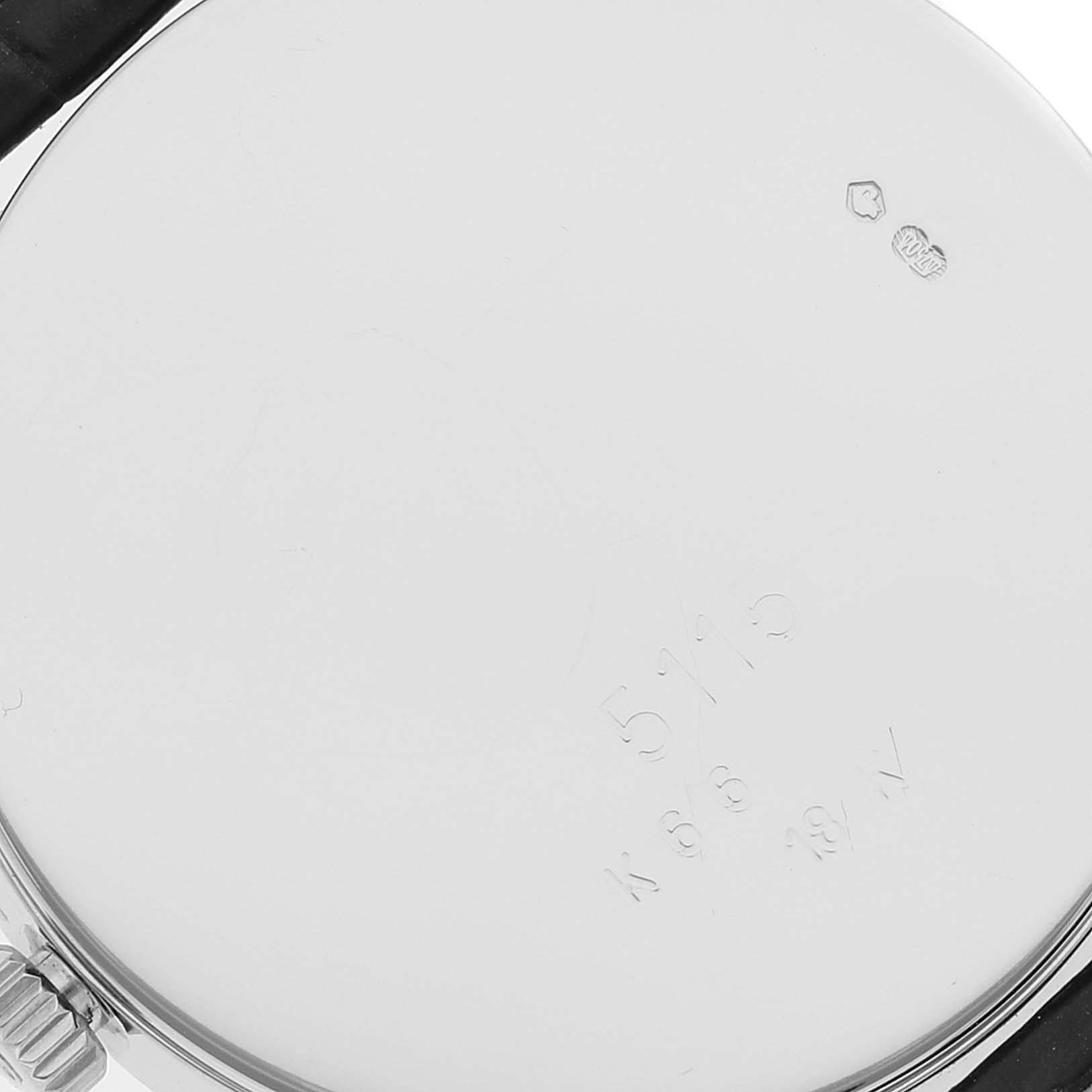 This is the back view of a Rolex Cellini 5115 Men's White Gold Silver Dial 5115 Men's White Gold Silver Dial watch, showing the case back with inscriptions and part of the strap attached.