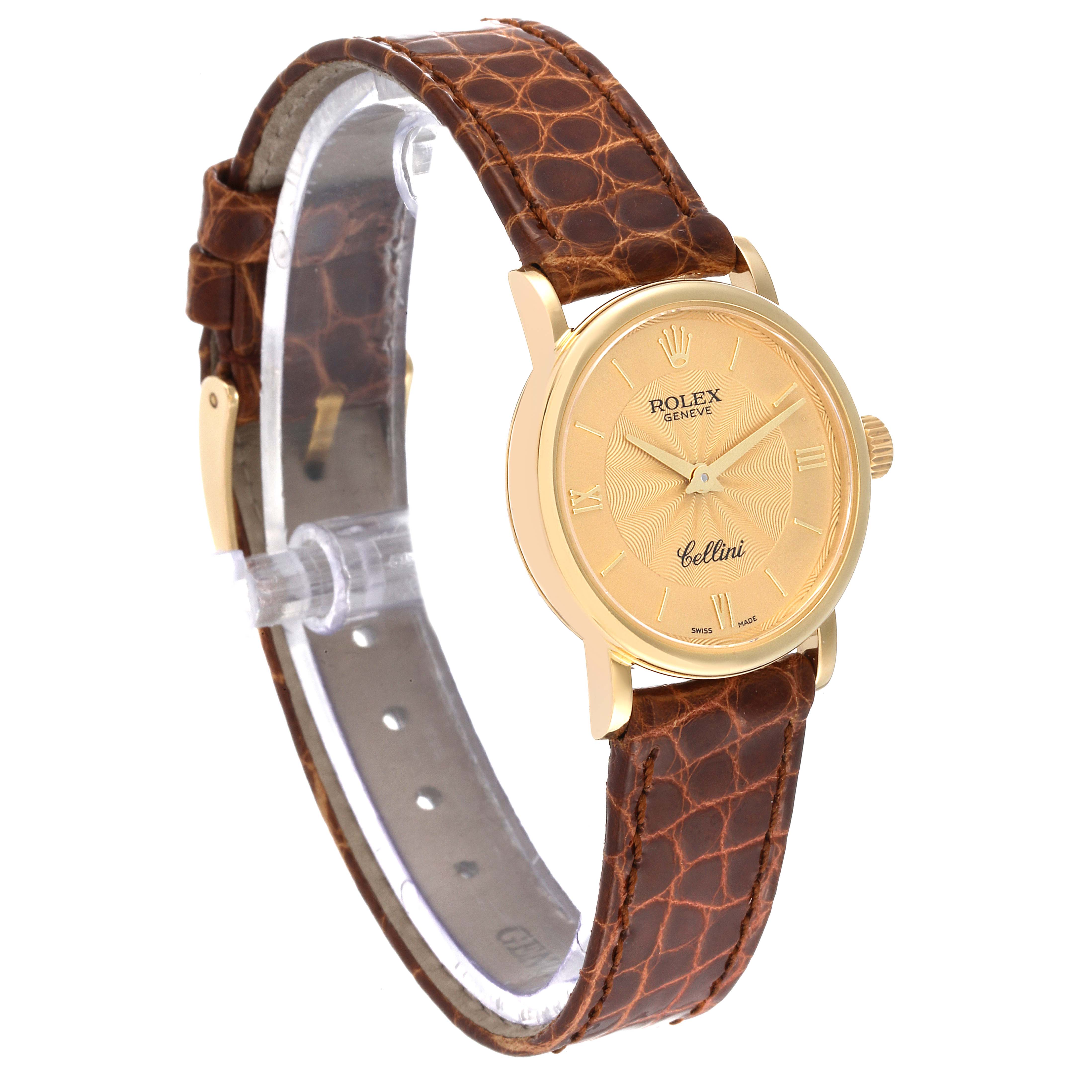 The image shows a partial side angle of a Rolex Cellini 6110/8 Women's Yellow Gold Champagne Dial 6110/8 Women's Yellow Gold Champagne Dial watch with a gold case and brown leather strap.