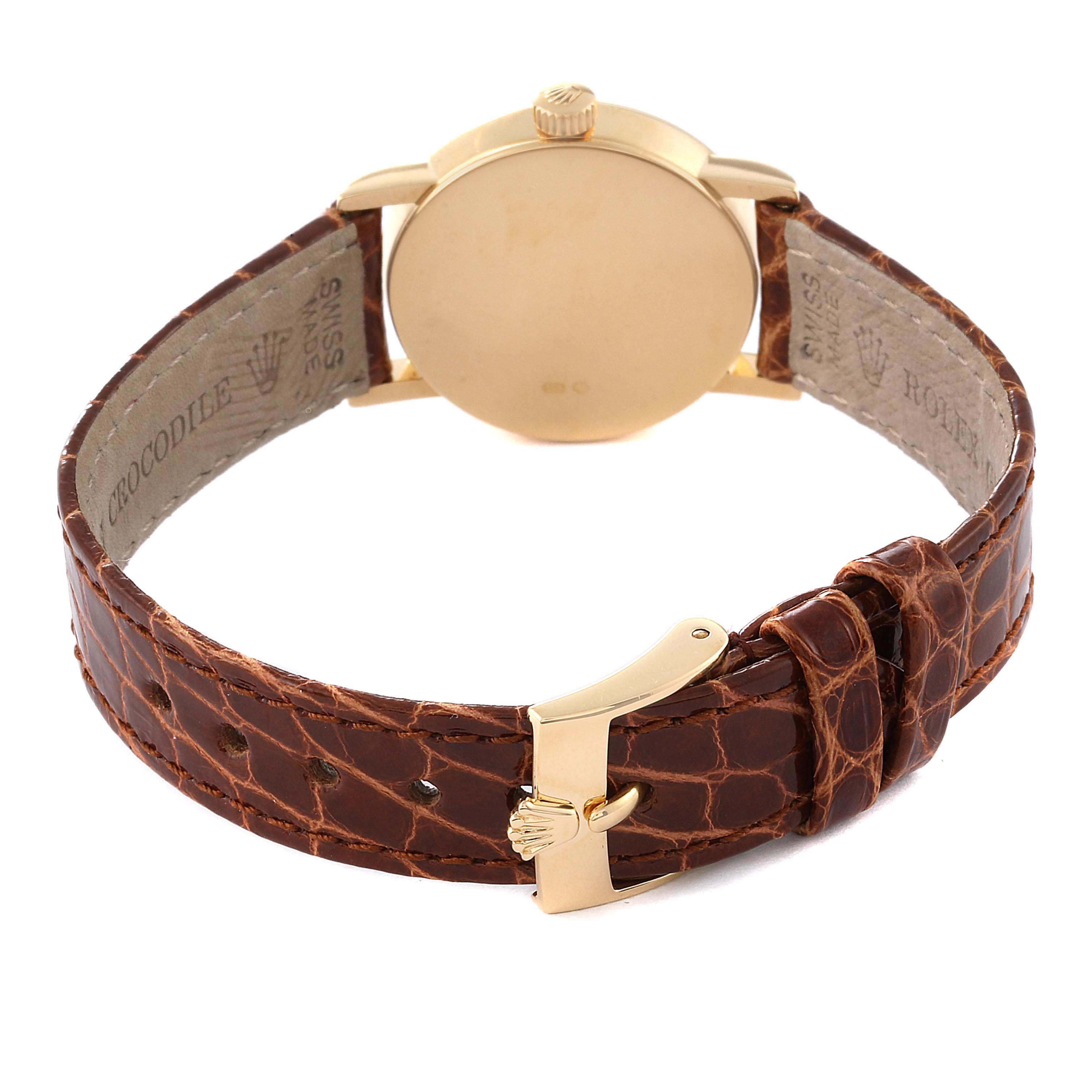 The Rolex Cellini 6110/8 Women's Yellow Gold Champagne Dial 6110/8 Women's Yellow Gold Champagne Dial watch is shown from the back, displaying the case, crown, and brown crocodile leather strap with a gold buckle.