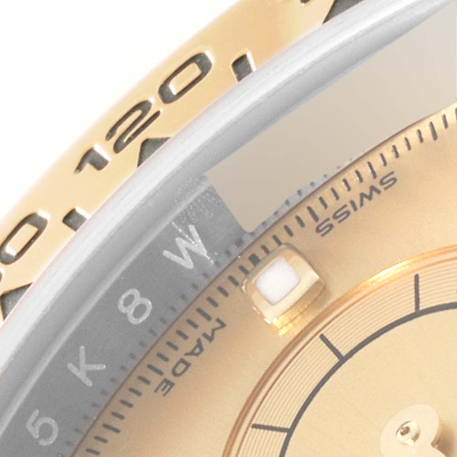 The image shows a close-up of the bezel and part of the dial of a Rolex Daytona 116503 Men's Steel and Gold (two tone) Champagne Dial 116503 Men's Steel and Gold (two tone) Champagne Dial watch.