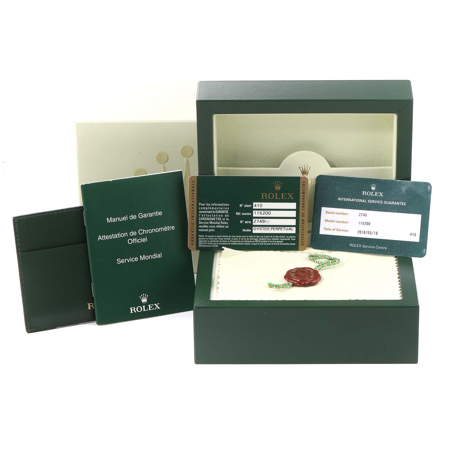 The image shows the box, warranty manual, chronometer certificate, and service card for a Rolex Date 115200 Men's Stainless Steel Blue Dial 115200 Men's Stainless Steel Blue Dial model watch.