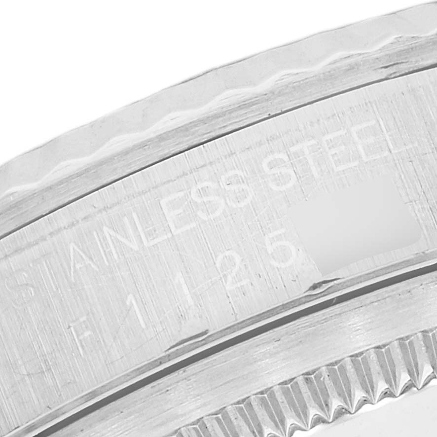 The image shows a close-up of the engraved case back and fluted bezel of a Rolex Datejust 16234 Men's Stainless Steel Silver Dial 16234 Men's Stainless Steel Silver Dial watch.