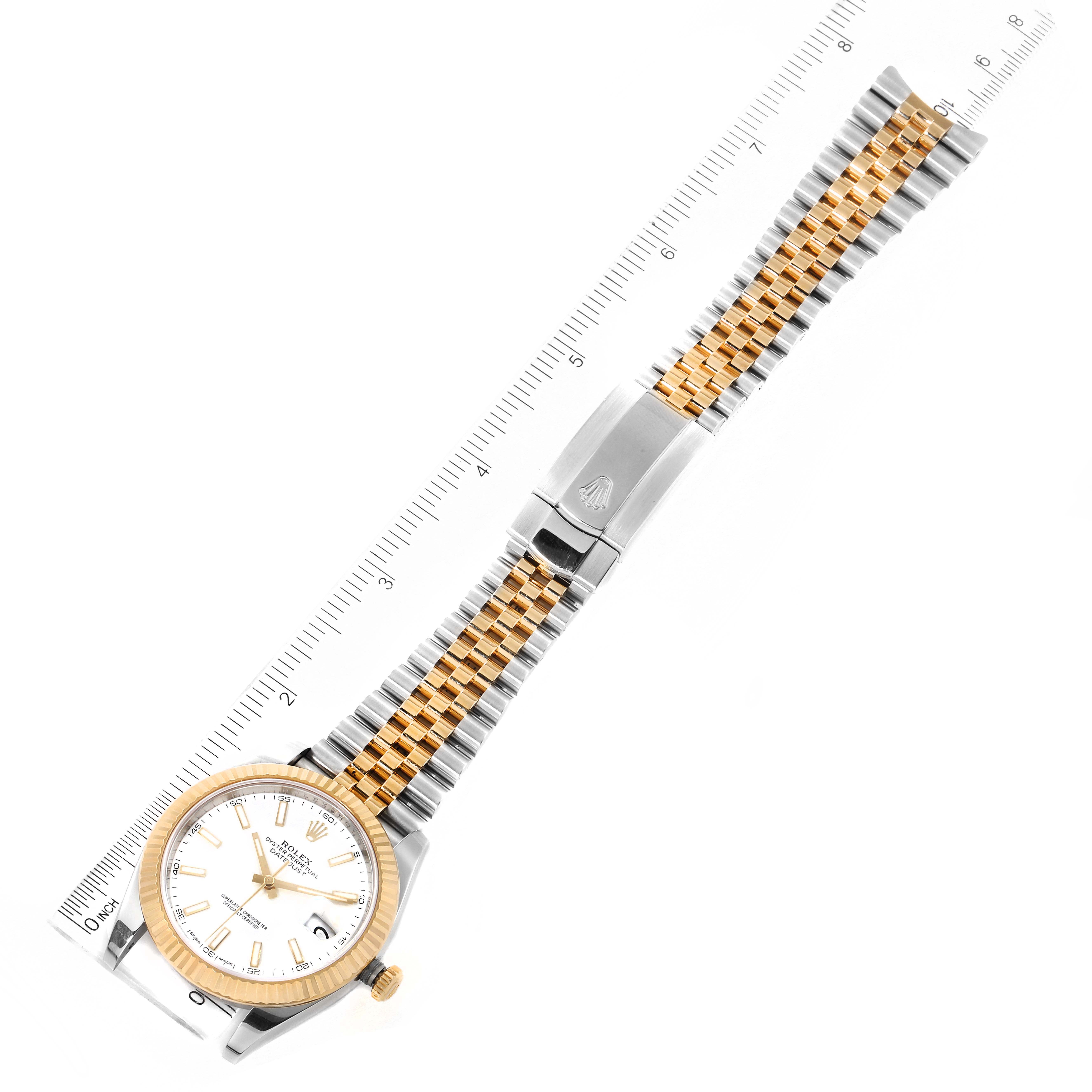 The image shows a Rolex Datejust 41 126333 Men's Steel and Gold (two tone) White Dial 126333 Men's Steel and Gold (two tone) White Dial watch laid flat, highlighting the face, bezel, crown, and bracelet with a ruler beside it.