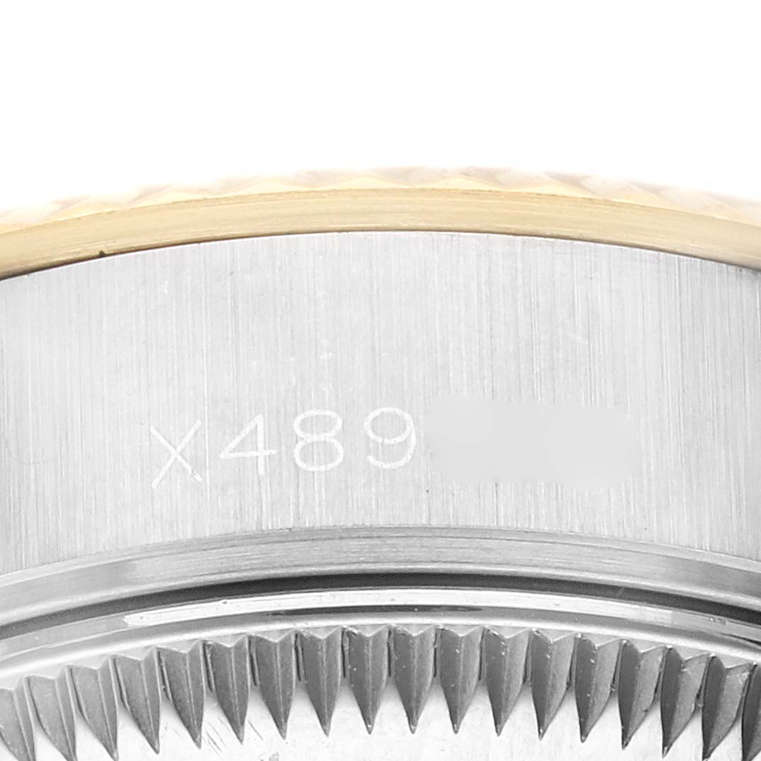 This close-up image shows the side and partially the bezel of a Rolex Datejust 69173G Women's Steel and Gold (two tone) Champagne Dial 69173G Women's Steel and Gold (two tone) Champagne Dial watch with visible engraving.