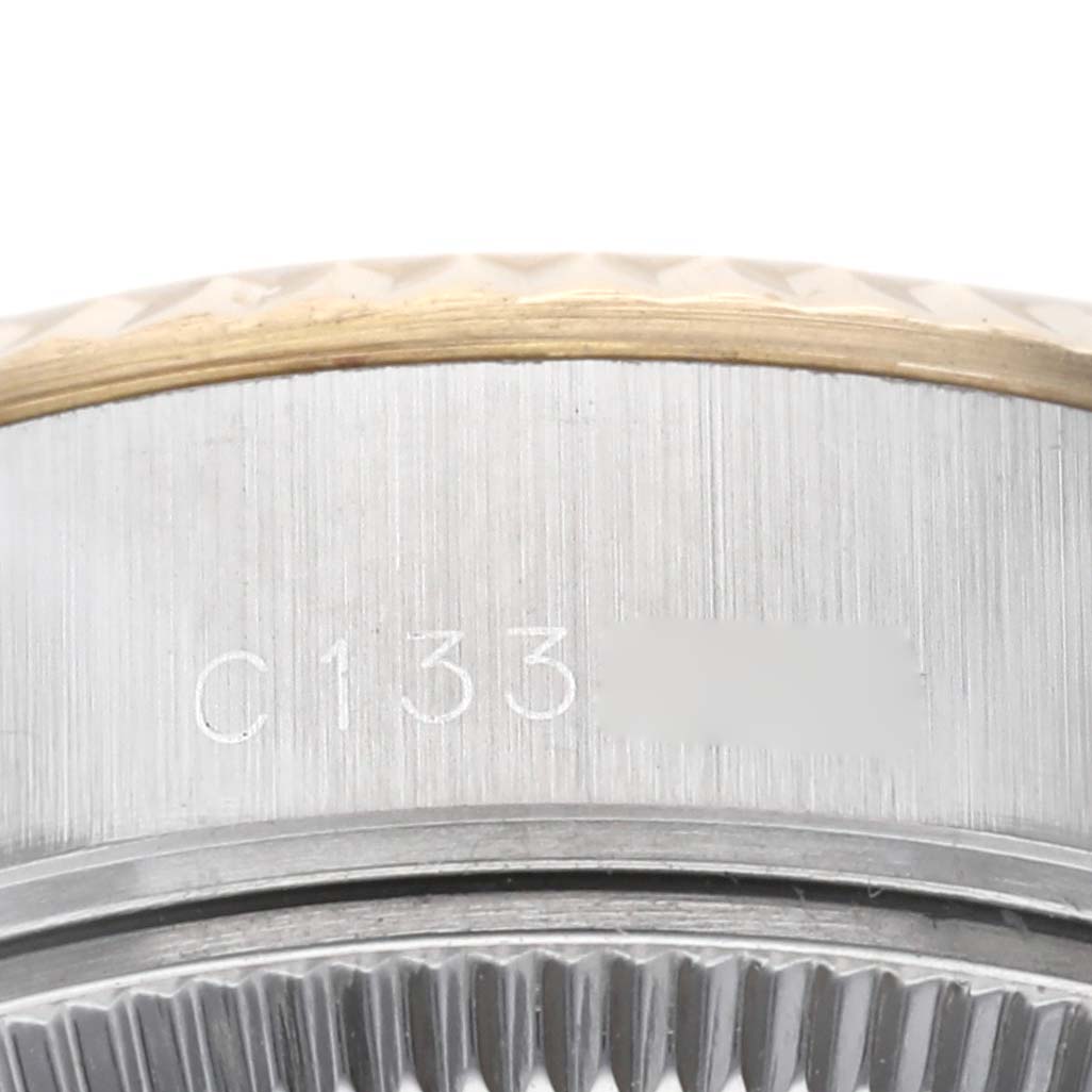 This image shows a close-up of the serial number engraving on the side case of the Rolex Datejust 69173G Women's Steel and Gold (two tone) Champagne Dial 69173G Women's Steel and Gold (two tone) Champagne Dial watch.