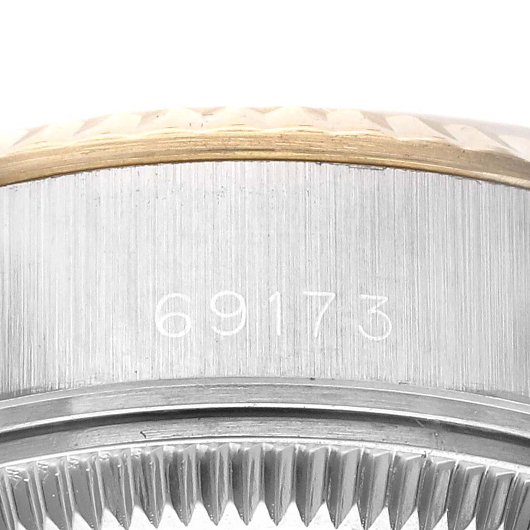 This close-up image shows the side of the Rolex Datejust 69173G Women's Steel and Gold (two tone) Champagne Dial 69173G Women's Steel and Gold (two tone) Champagne Dial model, highlighting the watch's case with the model number 69173 engraved.