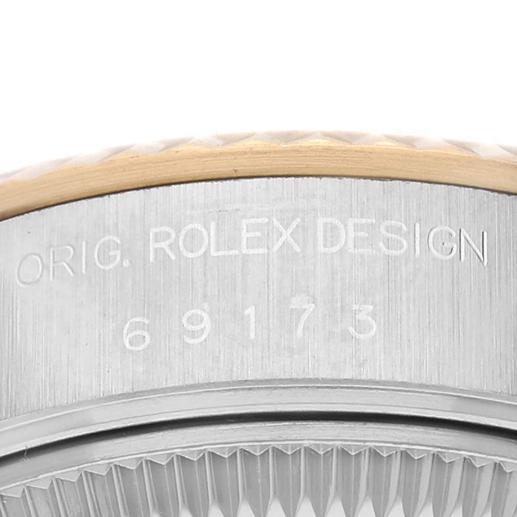 This image shows a close-up of the case side and bezel of a Rolex Datejust 69173G Women's Steel and Gold (two tone) Champagne Dial 69173G Women's Steel and Gold (two tone) Champagne Dial, featuring the engraved model and design number.