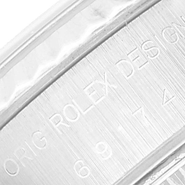 This close-up image shows the engraved serial number and branding on the case edge of a Rolex Datejust 69174 Women's Stainless Steel Pink Dial 69174 Women's Stainless Steel Pink Dial watch.
