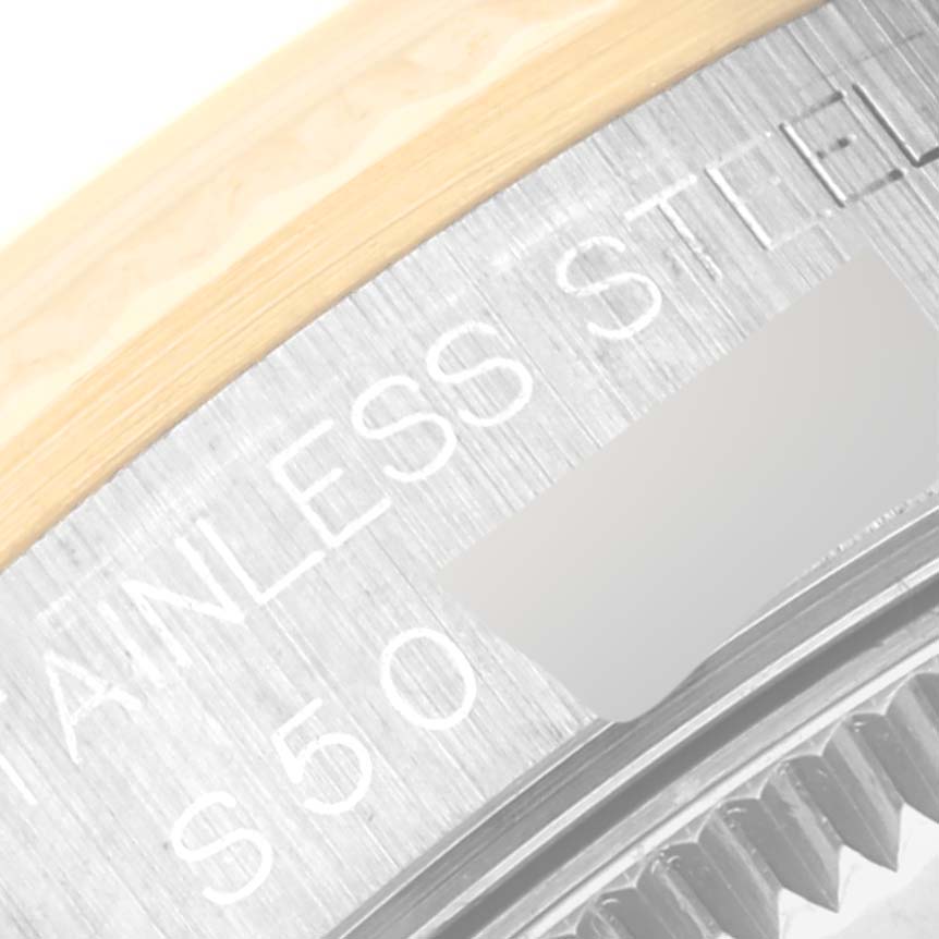 This close-up angle shows part of the stainless steel back casing and a portion of the bezel of the Rolex Mid-Size 68273 Women's Steel and Gold (two tone) Black Dial 68273 Women's Steel and Gold (two tone) Black Dial model watch.