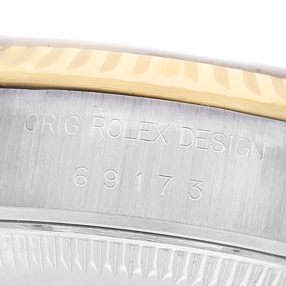 The image shows a close-up of the case of a Rolex Datejust 69173 Women's Stainless Steel Beige Dial, highlighting the engraved model number and design details.