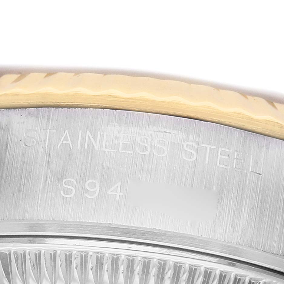 The image shows a close-up of the steel and gold bezel and edge engraving on the Rolex Datejust 69173 Women's Stainless Steel Beige Dial model.