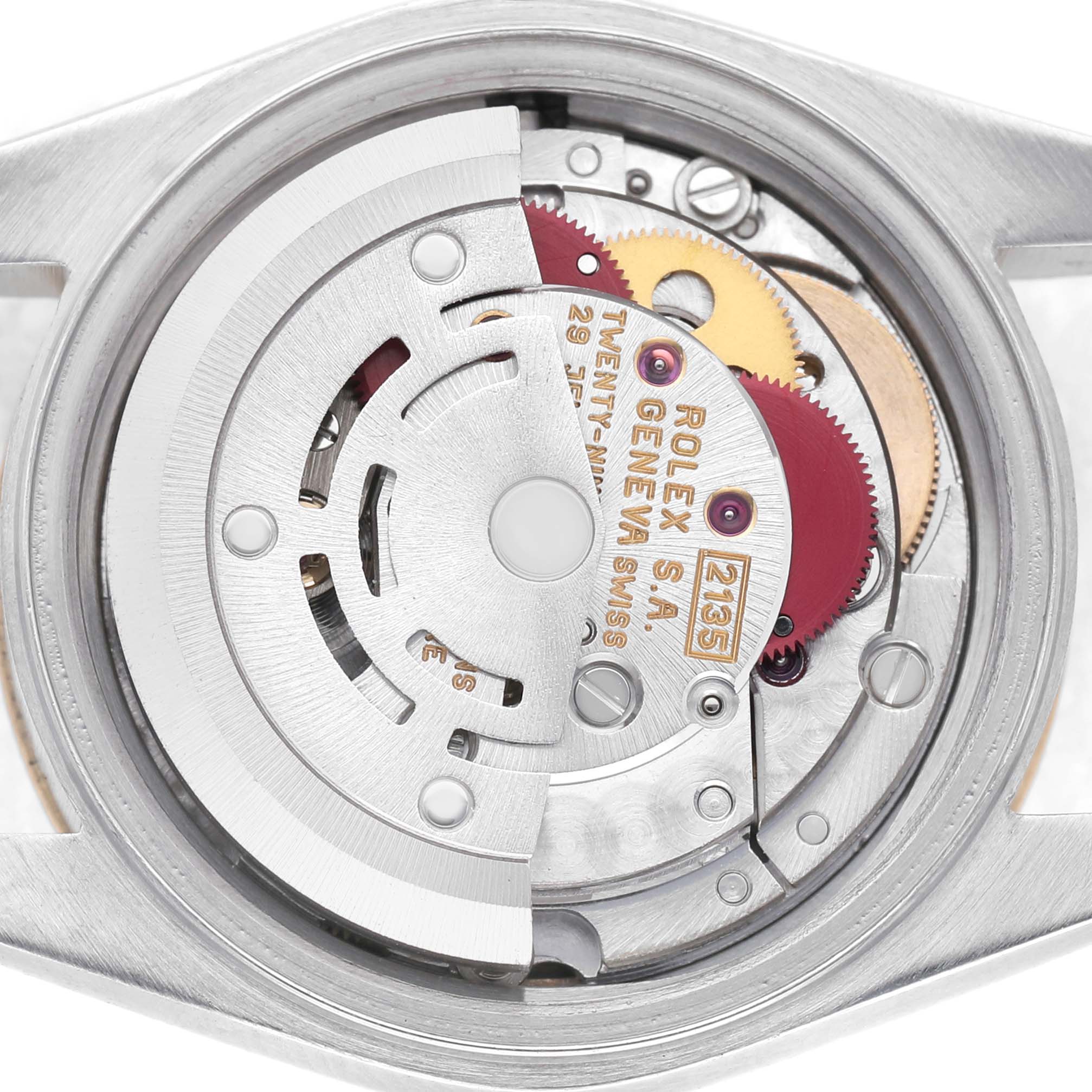 The image shows the internal movement mechanism of a Rolex Datejust 69173 Women's Stainless Steel Beige Dial, highlighting gears and the rotor from the back.