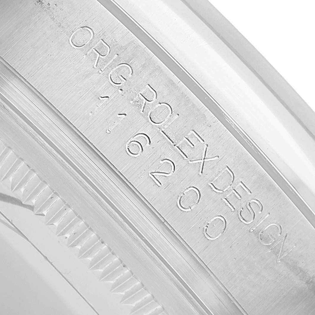 The image shows a close-up of the rim edge of a Rolex Datejust 116200 Men's Stainless Steel Silver Dial, featuring the engraved model information on the inner bezel.
