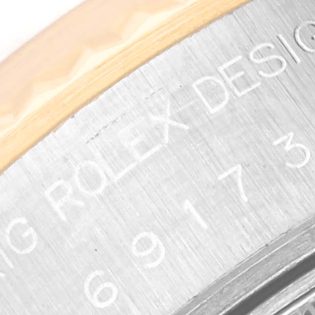 This image shows a close-up of the bezel and case, featuring engravings on the Rolex Datejust 69173 Women's Steel and Gold (two tone) Grey Dial 69173 Women's Steel and Gold (two tone) Grey Dial watch.