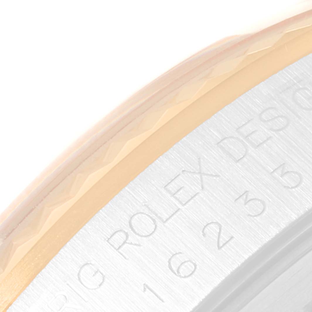 This image shows a close-up of the bezel and part of the case of a Rolex Datejust 16233 Men's Steel and Gold (two tone) White Dial 16233 Men's Steel and Gold (two tone) White Dial watch.