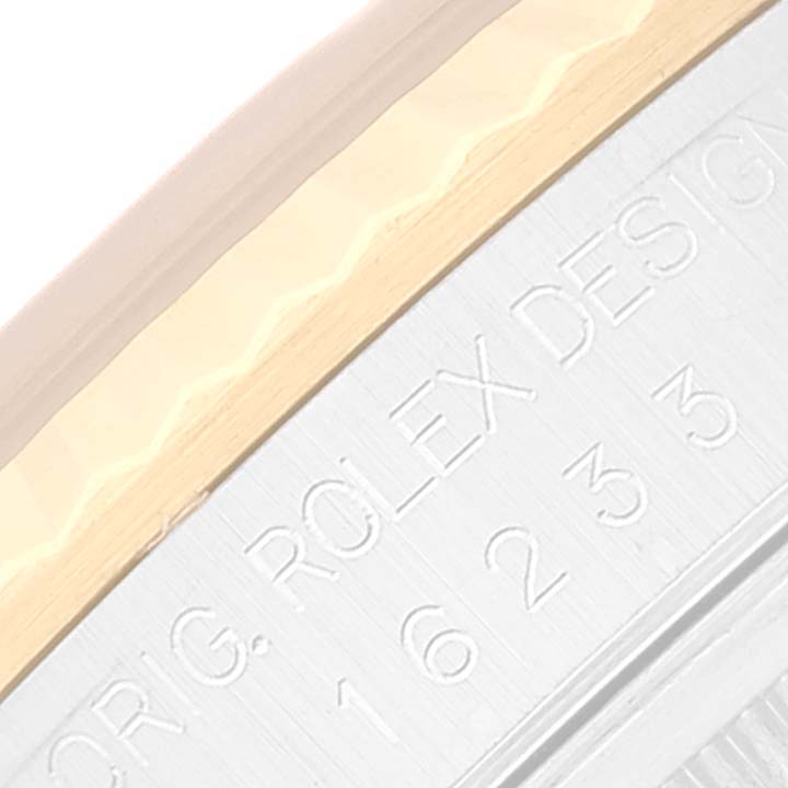 This close-up image shows the engraved case side of a Rolex Datejust 16233 Men's Steel and Gold (two tone) White Dial 16233 Men's Steel and Gold (two tone) White Dial watch.
