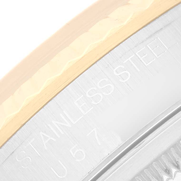 This close-up image of a Rolex Datejust 16233 Men's Steel and Gold (two tone) White Dial 16233 Men's Steel and Gold (two tone) White Dial watch highlights the stainless steel casing and part of the fluted bezel.