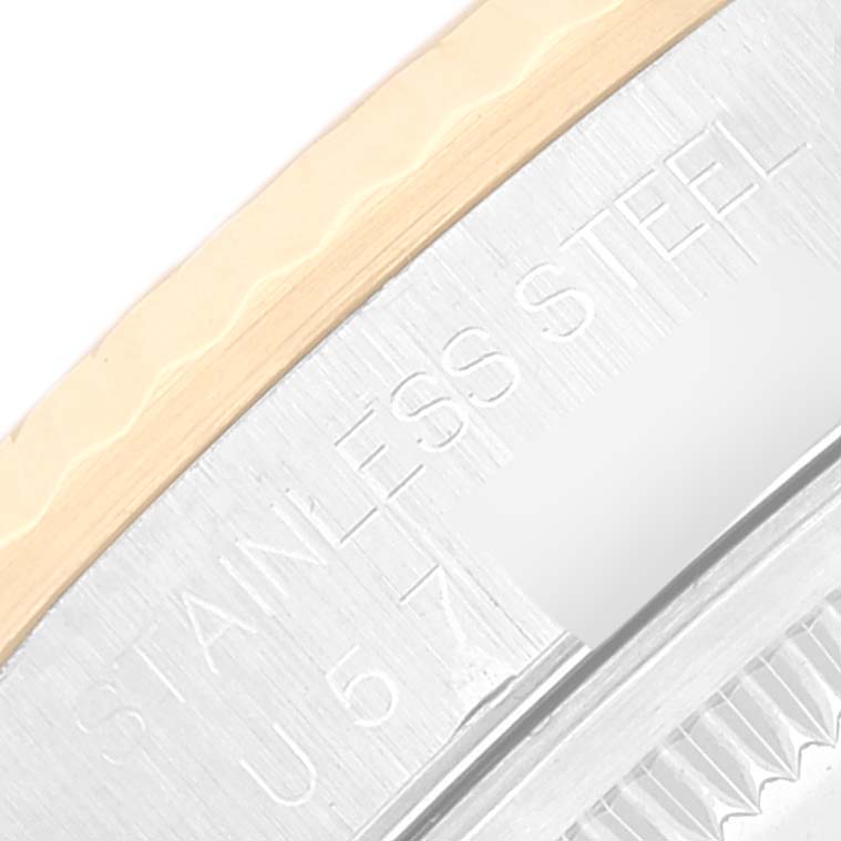 This close-up angle of the Rolex Datejust 16233 Men's Steel and Gold (two tone) Silver Dial 16233 Men's Steel and Gold (two tone) Silver Dial watch shows the stainless steel casing with engraved text.