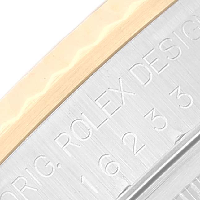 Close-up of the bezel and engraved inner ring of a Rolex Datejust 16233 Men's Steel and Gold (two tone) Silver Dial 16233 Men's Steel and Gold (two tone) Silver Dial.