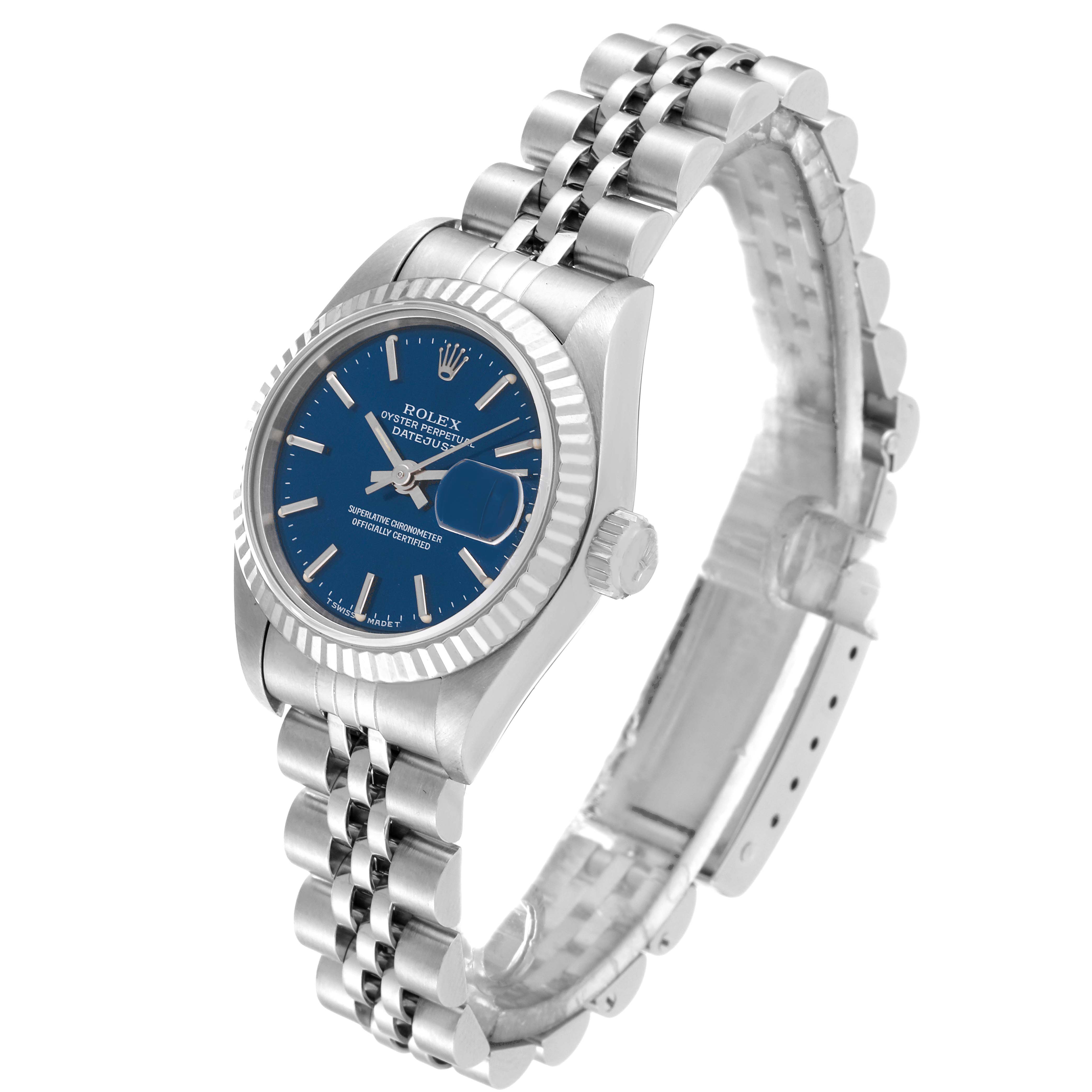 The image shows a Rolex Datejust 69174 Women's Stainless Steel Blue Dial 69174 Women's Stainless Steel Blue Dial watch from an angled side view, highlighting the blue dial, fluted bezel, and Jubilee bracelet.