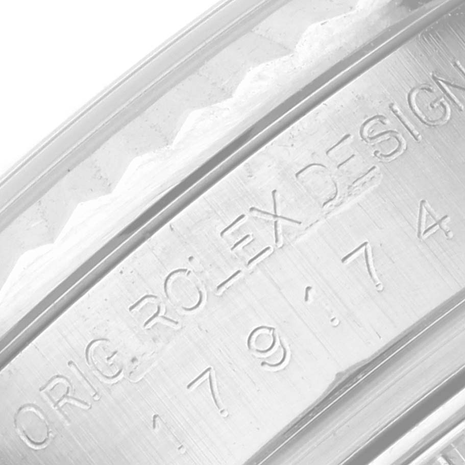 This image shows a close-up angle of the engraved inner bezel of a Rolex Datejust 179174 Women's Stainless Steel White Dial 179174 Women's Stainless Steel White Dial watch.