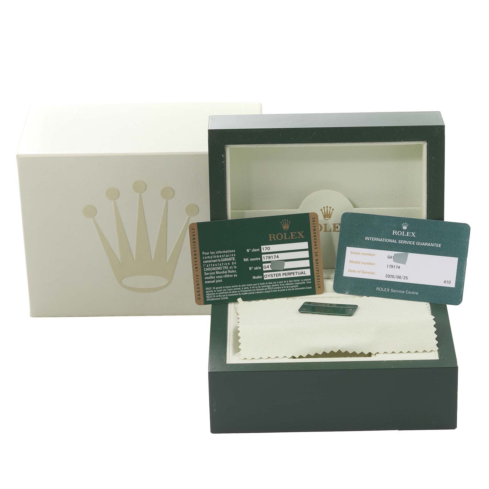 The image shows the packaging and accessories of a Rolex Datejust 179174 Women's Stainless Steel White Dial 179174 Women's Stainless Steel White Dial watch, including the box, guarantee cards, and a cleaning cloth.
