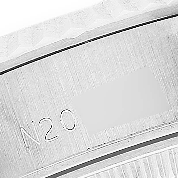 This close-up image shows part of the bezel and the engraved serial number of a Rolex Datejust 69174 Women's Stainless Steel Silver Dial 69174 Women's Stainless Steel Silver Dial watch.