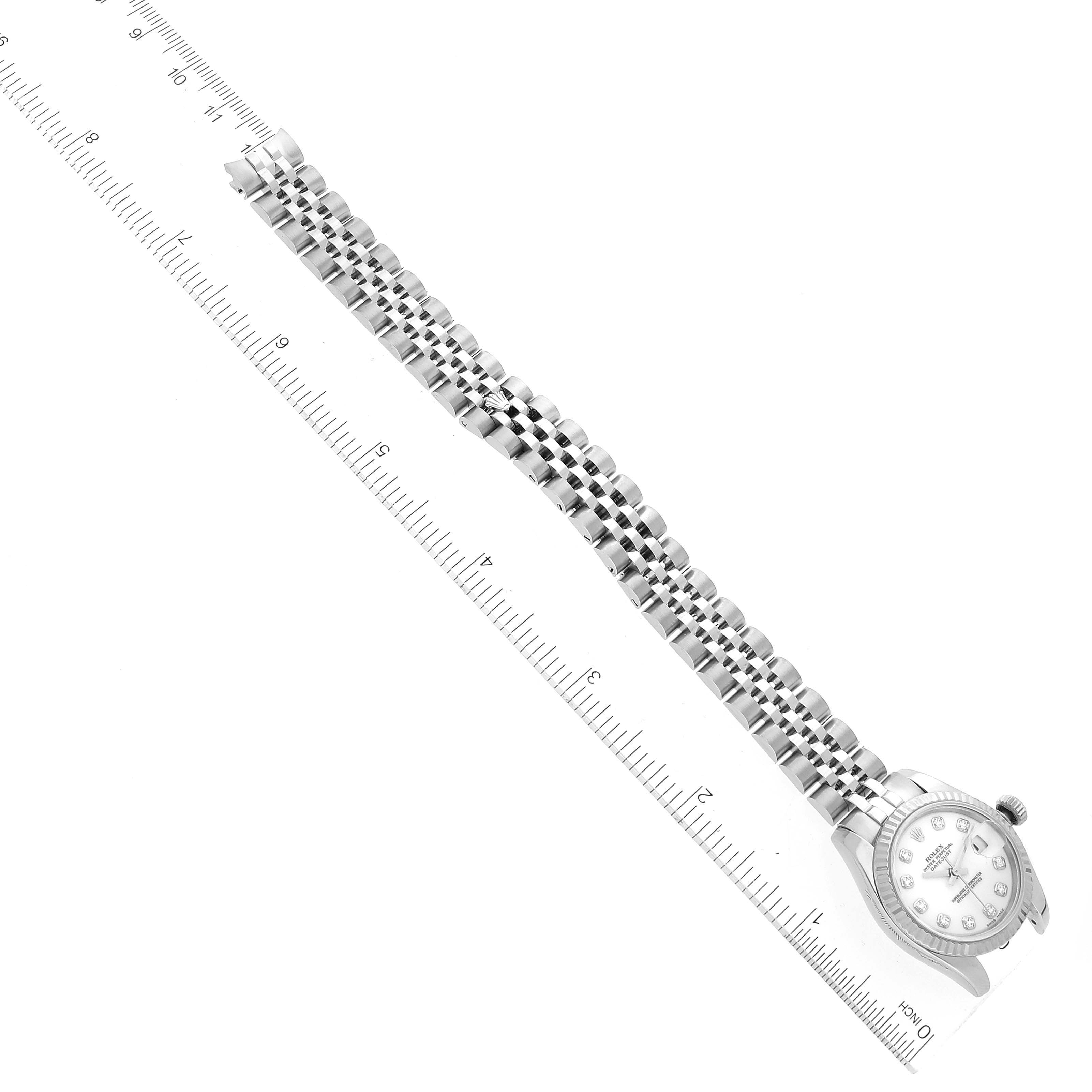 The image shows a Rolex Datejust 179174 Women's Stainless Steel White Dial 179174 Women's Stainless Steel White Dial watch laid flat with its bracelet extended, aligned next to a ruler for measurement.