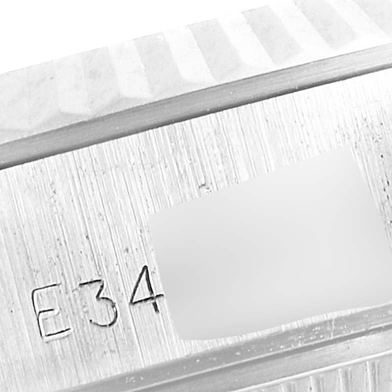 The image shows an engraved, close-up view of the case with part of the fluted bezel of a Rolex Datejust 69174 Women's Stainless Steel Silver Dial 69174 Women's Stainless Steel Silver Dial watch.