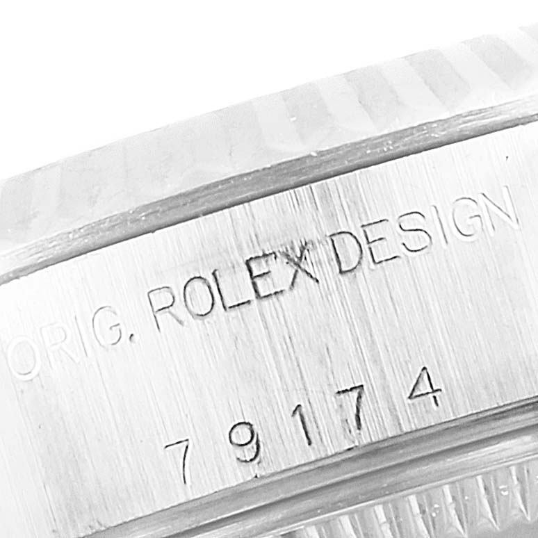 This image shows a close-up of the engraved case side of a Rolex Datejust 79174 Women's Stainless Steel Pink Dial 79174 Women's Stainless Steel Pink Dial watch, revealing the model number and design inscription.