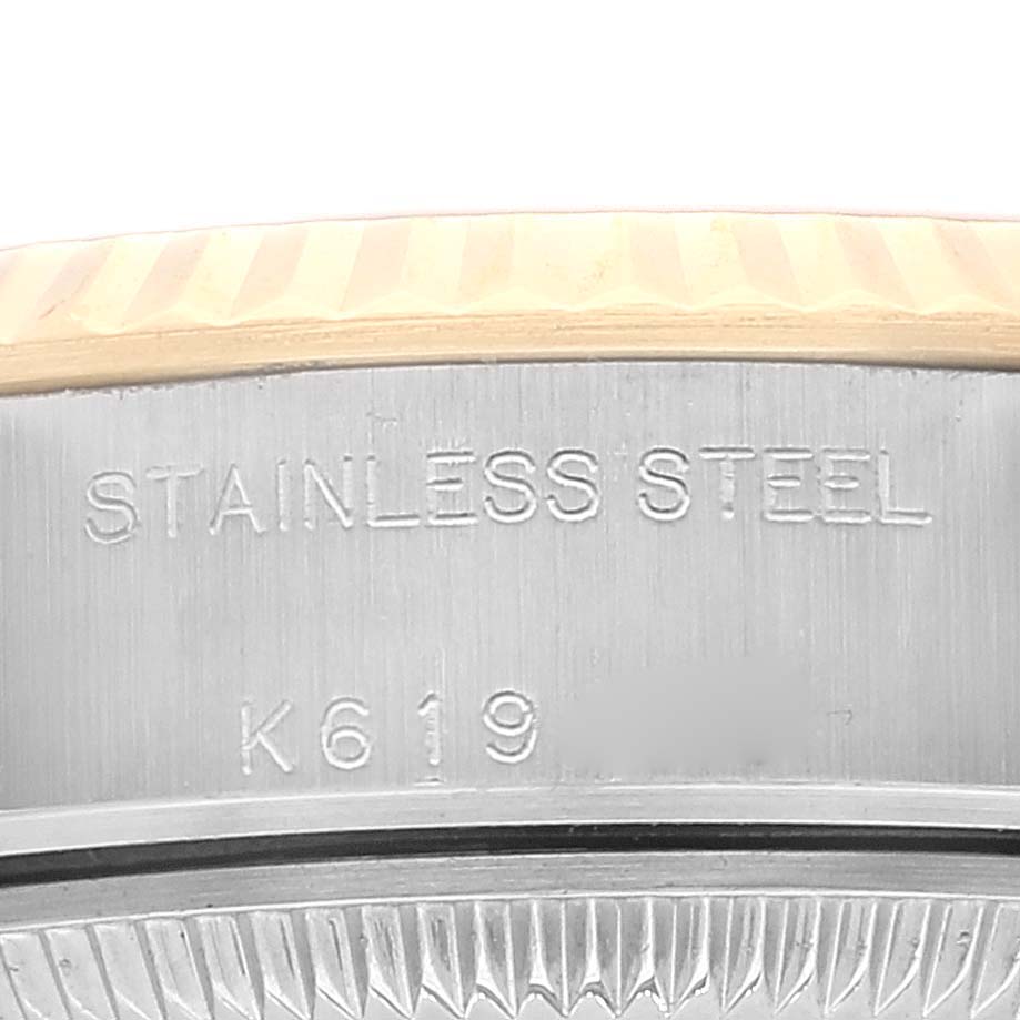 The image shows a close-up of the case back of a Datejust model by Rolex, displaying "STAINLESS STEEL" and a serial number.