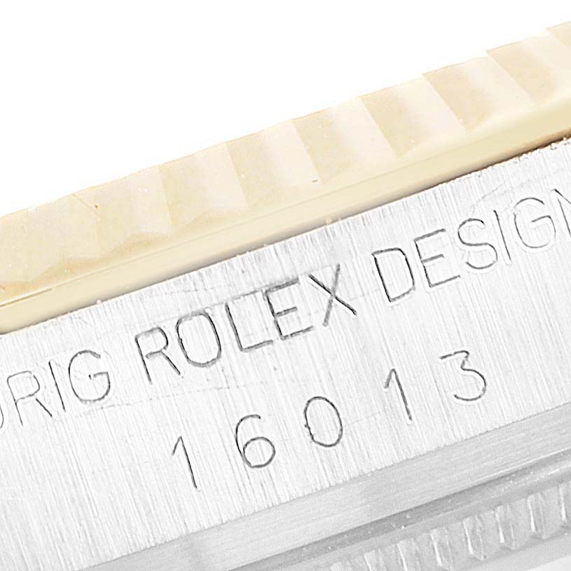 This close-up image shows the engraved model number and part of the bezel of the Rolex Vintage Collection 16013 Men's Steel and Gold (two tone) White Dial 16013 Men's Steel and Gold (two tone) White Dial.