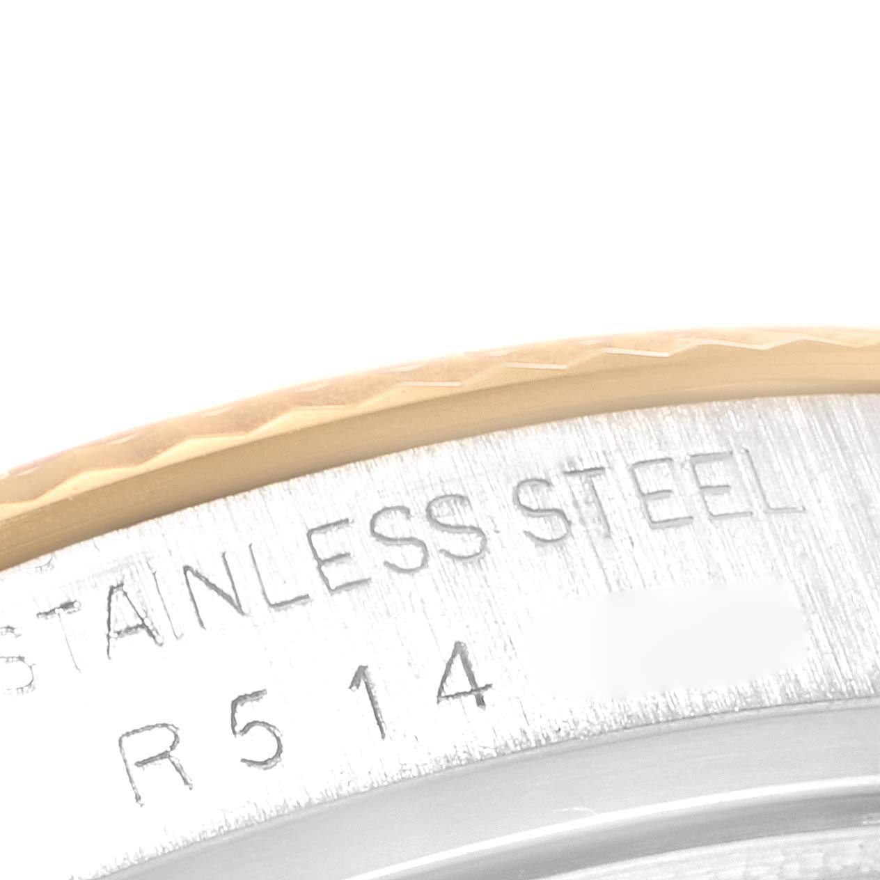 This close-up image shows the engraved part of the stainless steel case and bezel edge of the Vintage Collection model by Rolex.