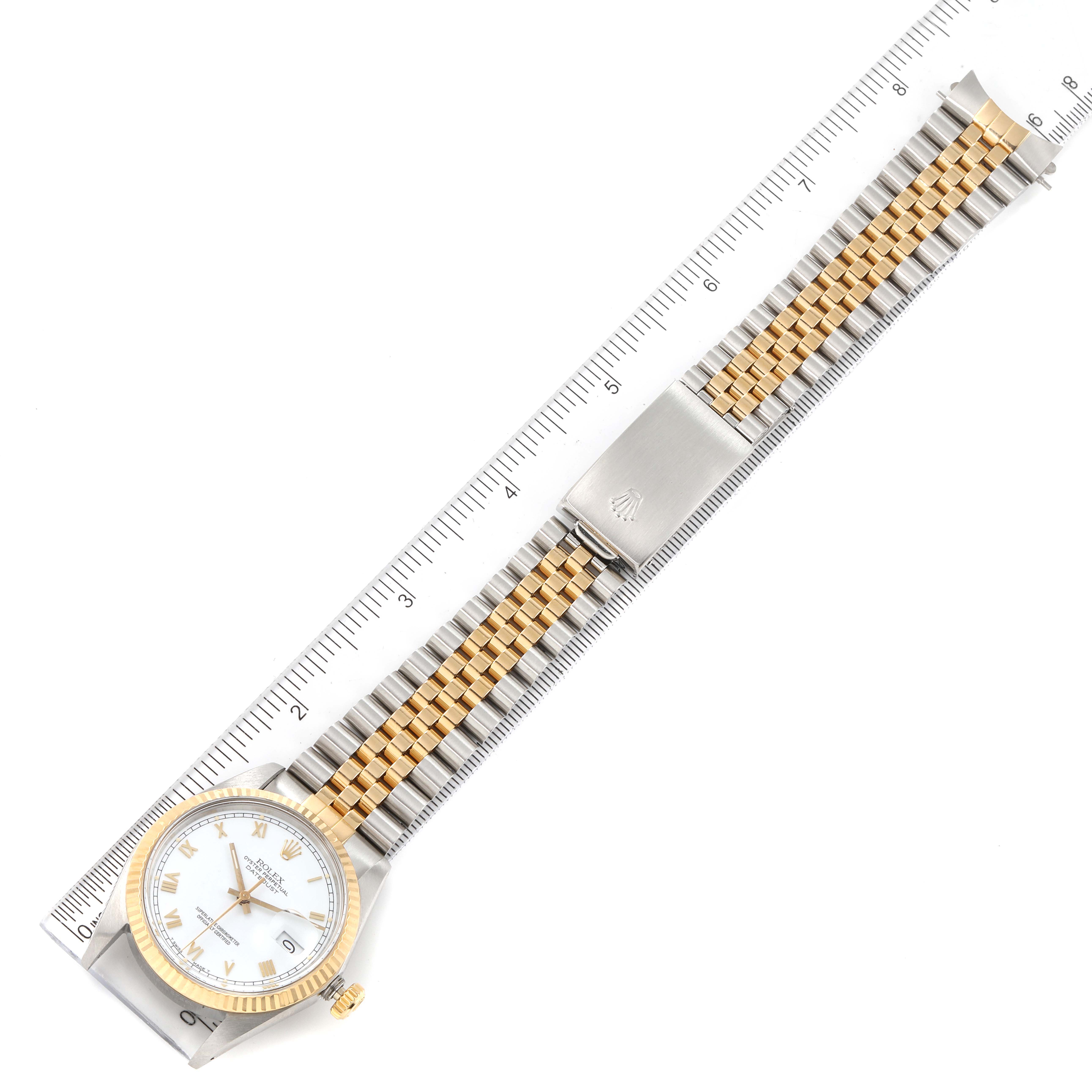 The Rolex Vintage Collection 16013 Men's Steel and Gold (two tone) White Dial 16013 Men's Steel and Gold (two tone) White Dial watch is shown from a top-down angle, displaying its face, bezel, and full metal band against a ruler.