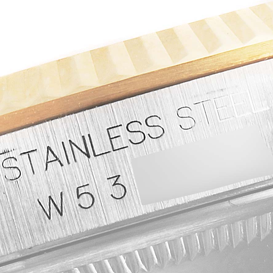 This image shows a close-up of the engraving on the side of a stainless steel Rolex Datejust 16233 Men's Steel and Gold (two tone) White Dial 16233 Men's Steel and Gold (two tone) White Dial watch case, near the gold bezel.