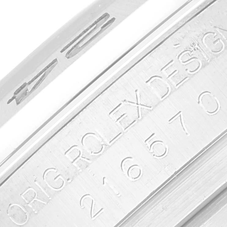 This close-up image shows the engraved serial number and "ORIG ROLEX DESIGN" on the inner case of a Rolex Explorer 216570 Men
s Stainless Steel Black Dial 216570 Men
s Stainless Steel Black Dial watch.