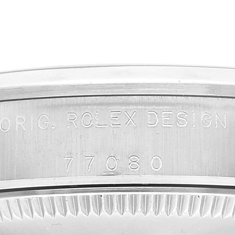 This is a close-up angle showing the engraved side of a Rolex Mid-Size 77080 Women
s Stainless Steel Blue Dial 77080 Women
s Stainless Steel Blue Dial watch with the model number 77080.