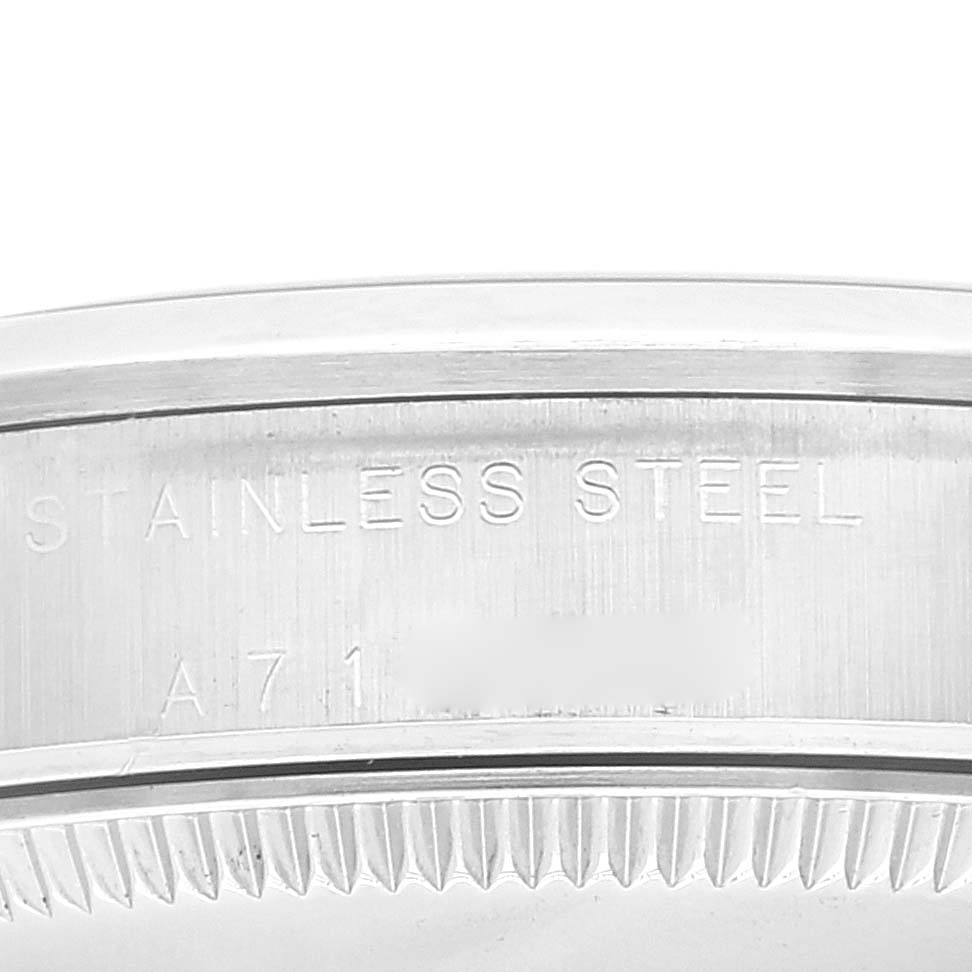 This image shows a close-up of the side of the case of a Rolex Mid-Size 77080 Women
s Stainless Steel Blue Dial 77080 Women
s Stainless Steel Blue Dial watch, highlighting the engraving "STAINLESS STEEL."