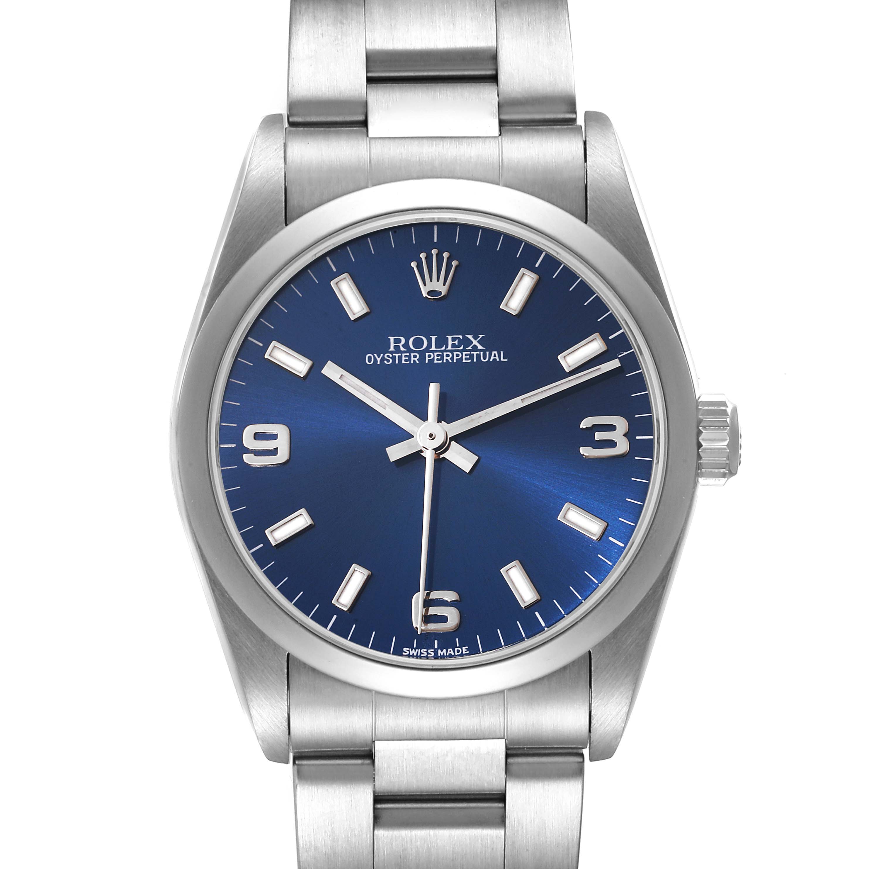 The Rolex Mid-Size 77080 Women
s Stainless Steel Blue Dial 77080 Women
s Stainless Steel Blue Dial Oyster Perpetual watch is photographed from the front, showing the dial, bracelet, hands, and crown.