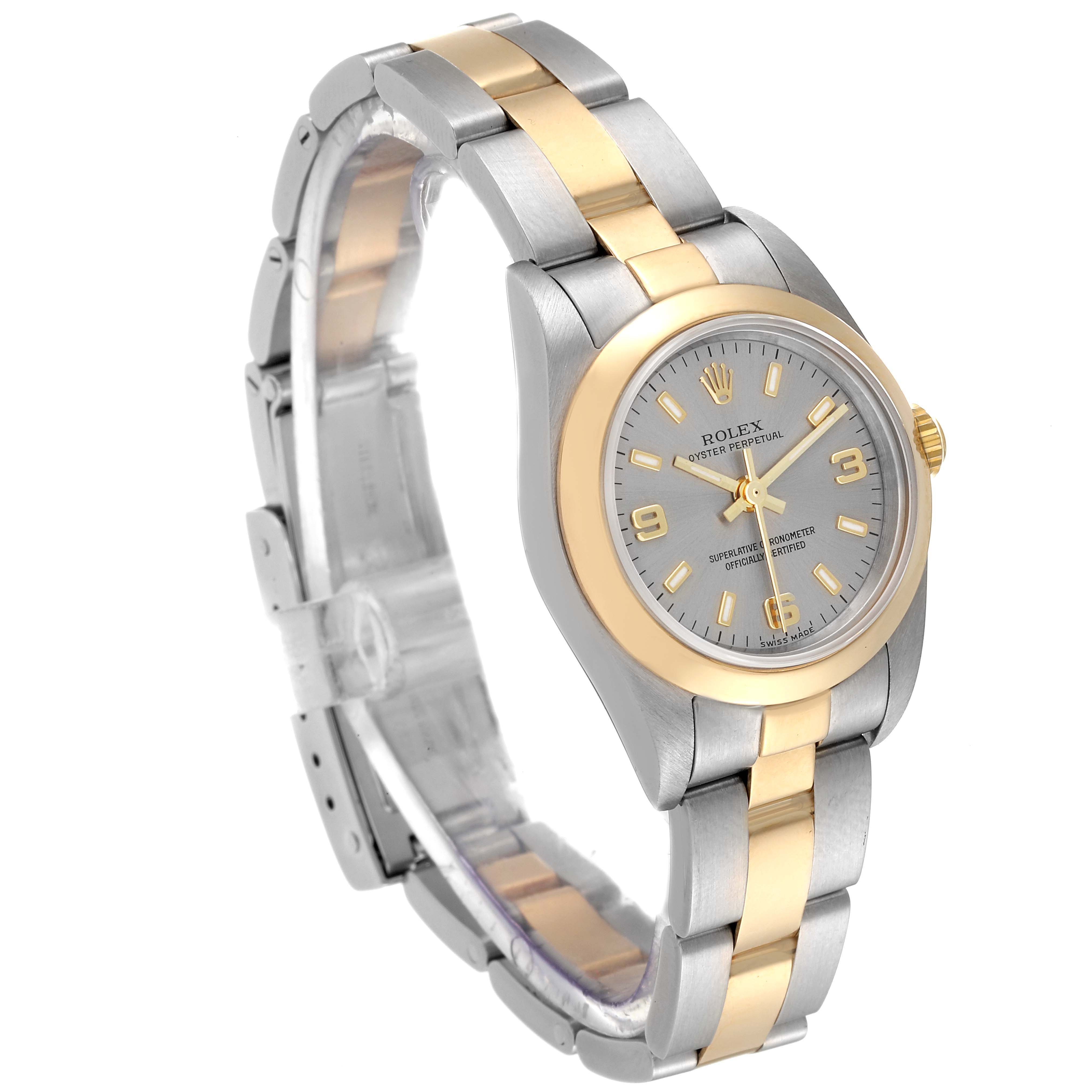 The image shows a Rolex Oyster Perpetual 76183 Women's Steel and Gold (two tone) Grey Dial 76183 Women's Steel and Gold (two tone) Grey Dial watch at a three-quarter angle, highlighting its two-tone metal bracelet and silver dial.