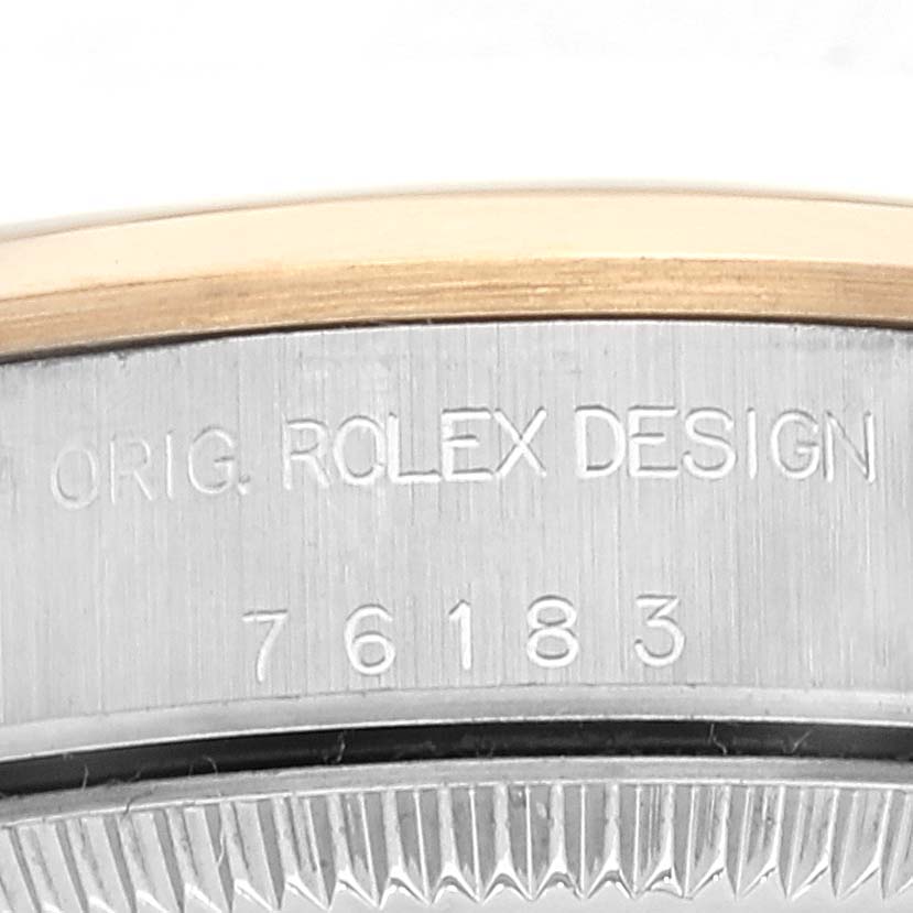 The image shows a close-up of the side casing of a Rolex Oyster Perpetual 76183 Women's Steel and Gold (two tone) Grey Dial 76183 Women's Steel and Gold (two tone) Grey Dial watch, displaying the model number 76183 and design engraving.