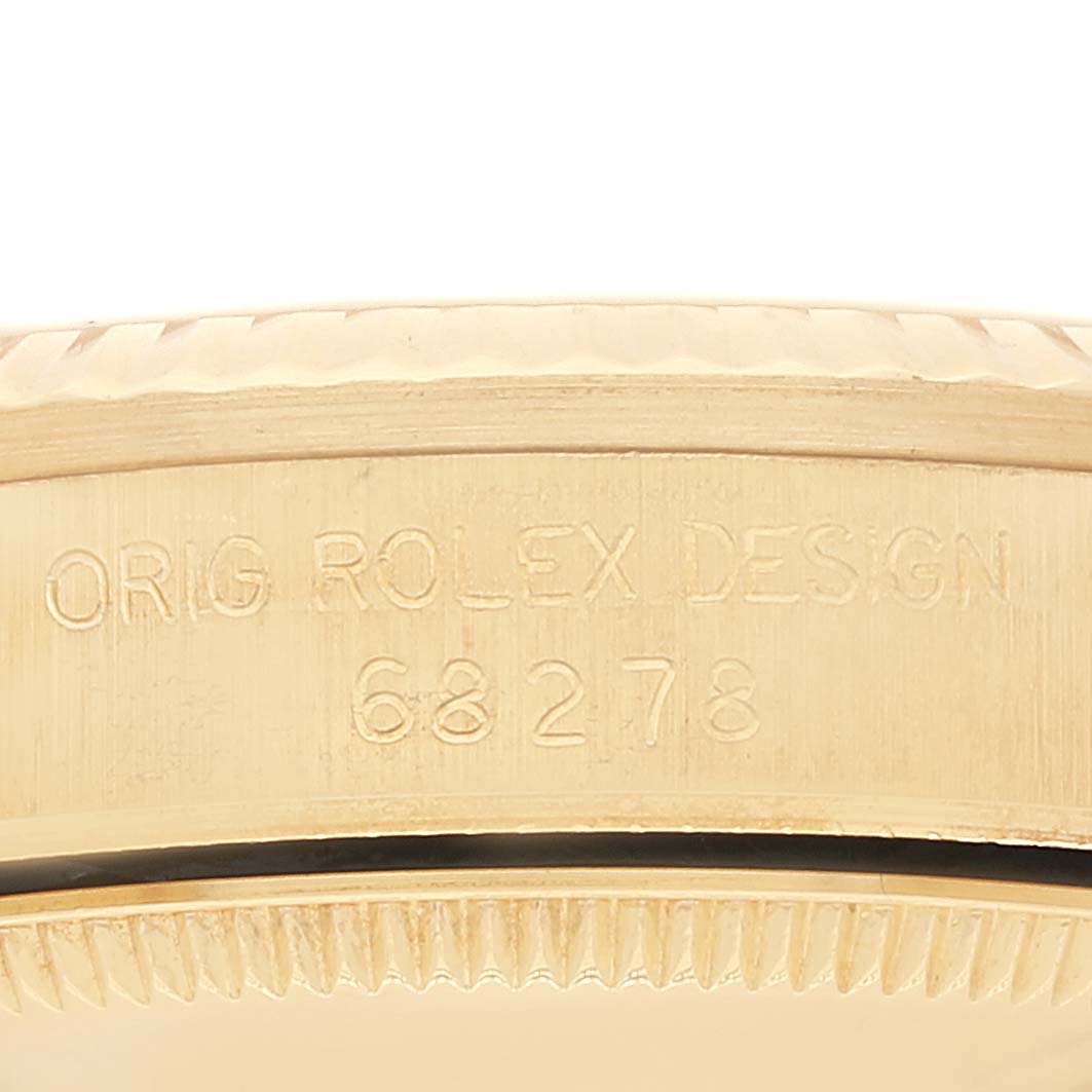 This close-up image shows the side of the Rolex President 68278 Women
s Yellow Gold Champagne Dial 68278 Women
s Yellow Gold Champagne Dial model
s case, highlighting the engraved design and model number.