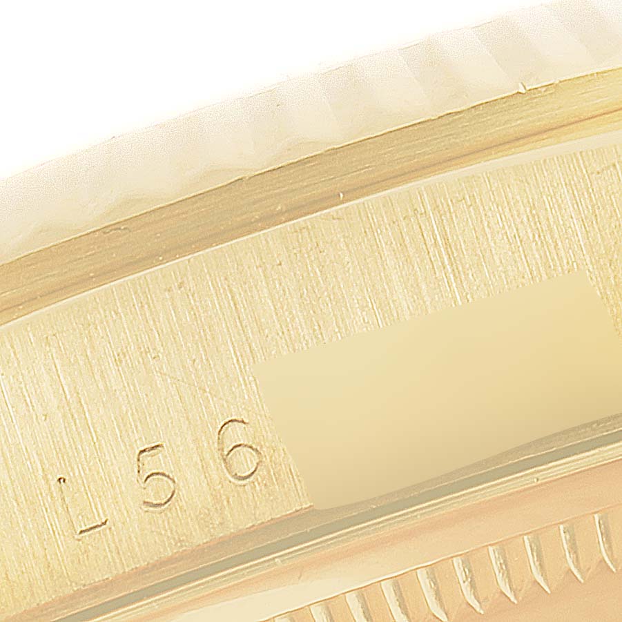 This close-up image shows part of the bezel and the case, including the serial number, of a Rolex President 18238 Men's Yellow Gold Champagne Dial 18238 Men's Yellow Gold Champagne Dial model watch.